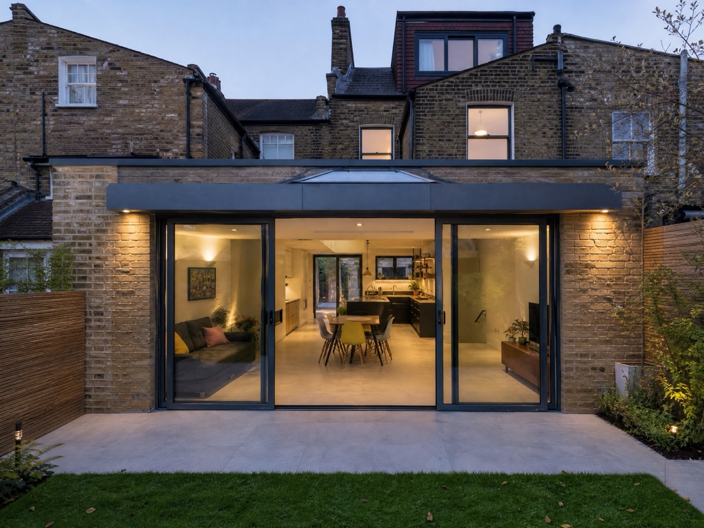 Concept image of a contemporary rear extension with large glazing and sliding doors to a garden