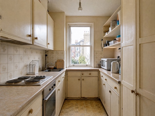 Cramped galley kitchen concept with dated cabinets and tiles