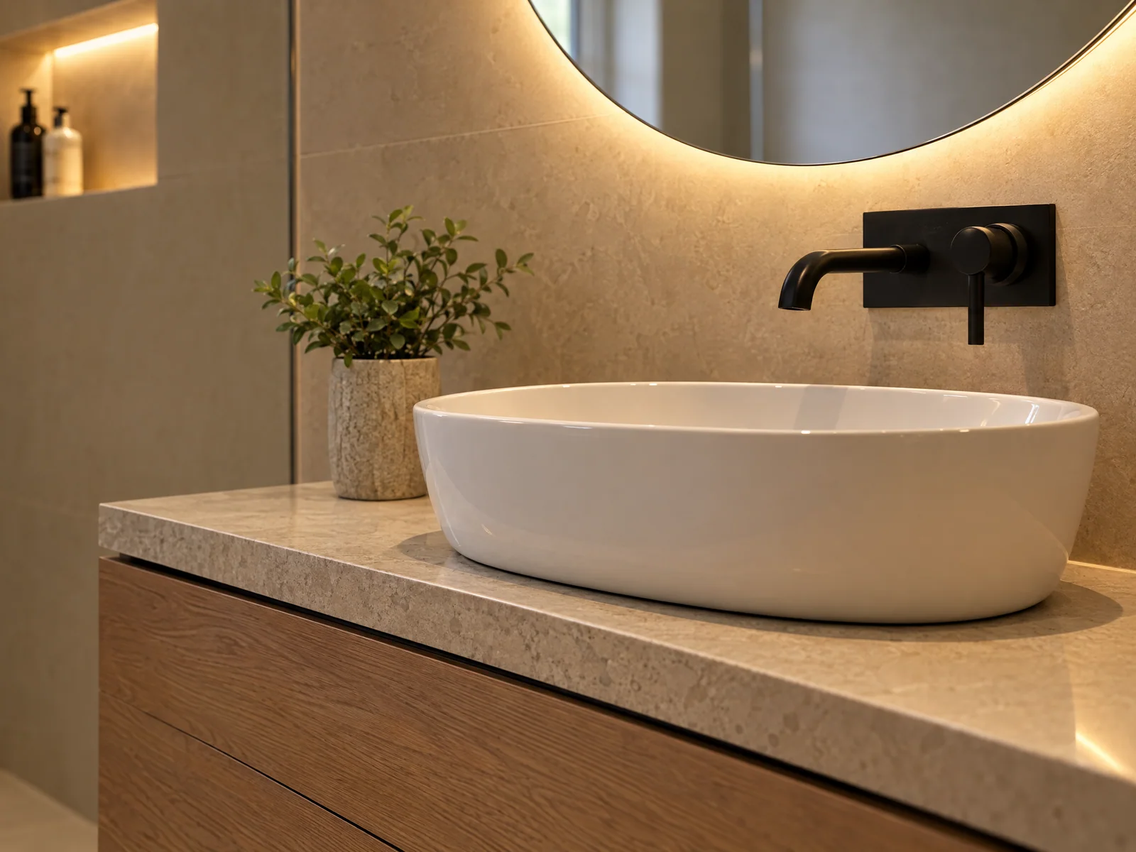 Oak, white ceramic, black tap and warm backlighting against stone-effect tiles